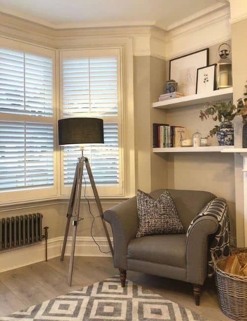 low level raw metal radiator under a window