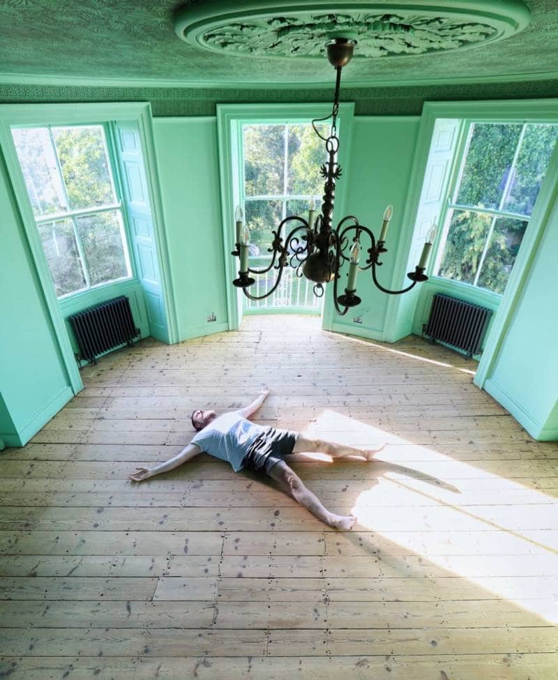 Greg lying on the floor in the party room
