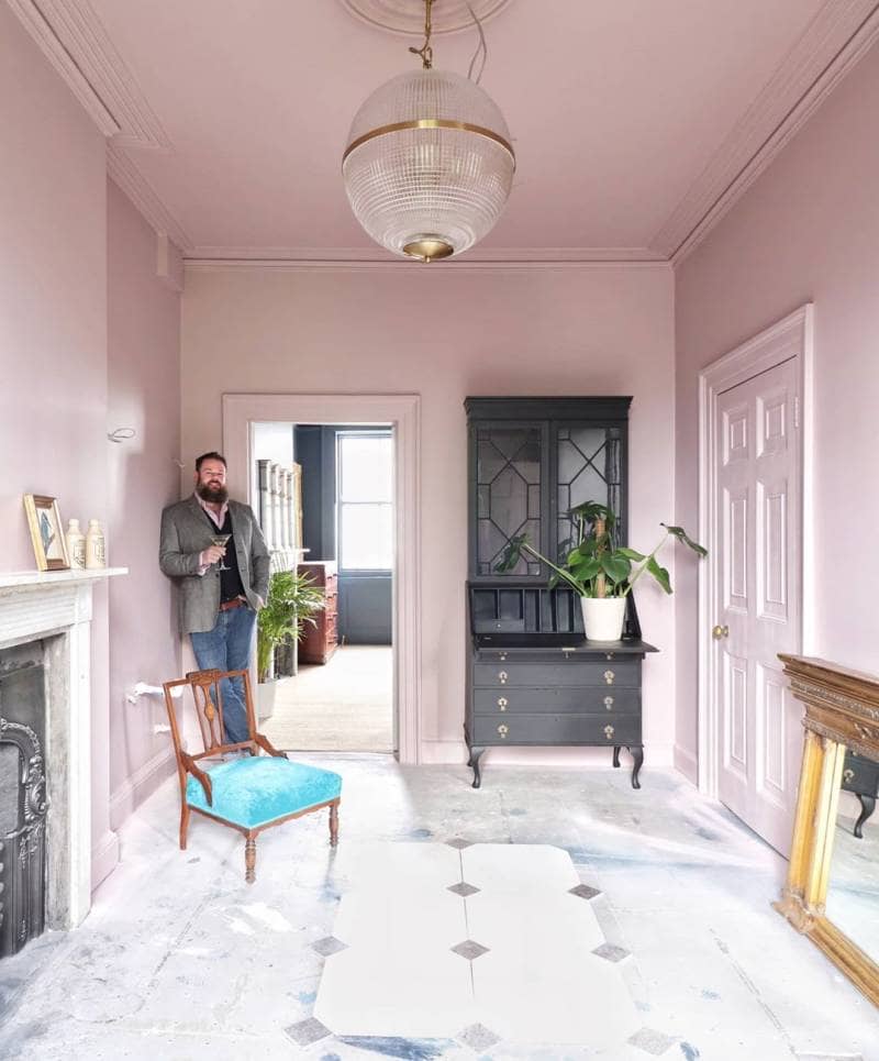 man stood in a pink room