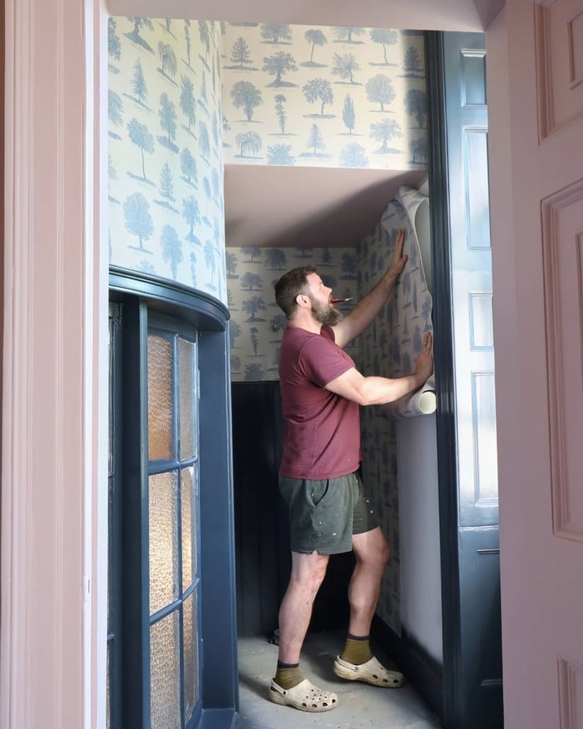 Greg putting up wallpaper
