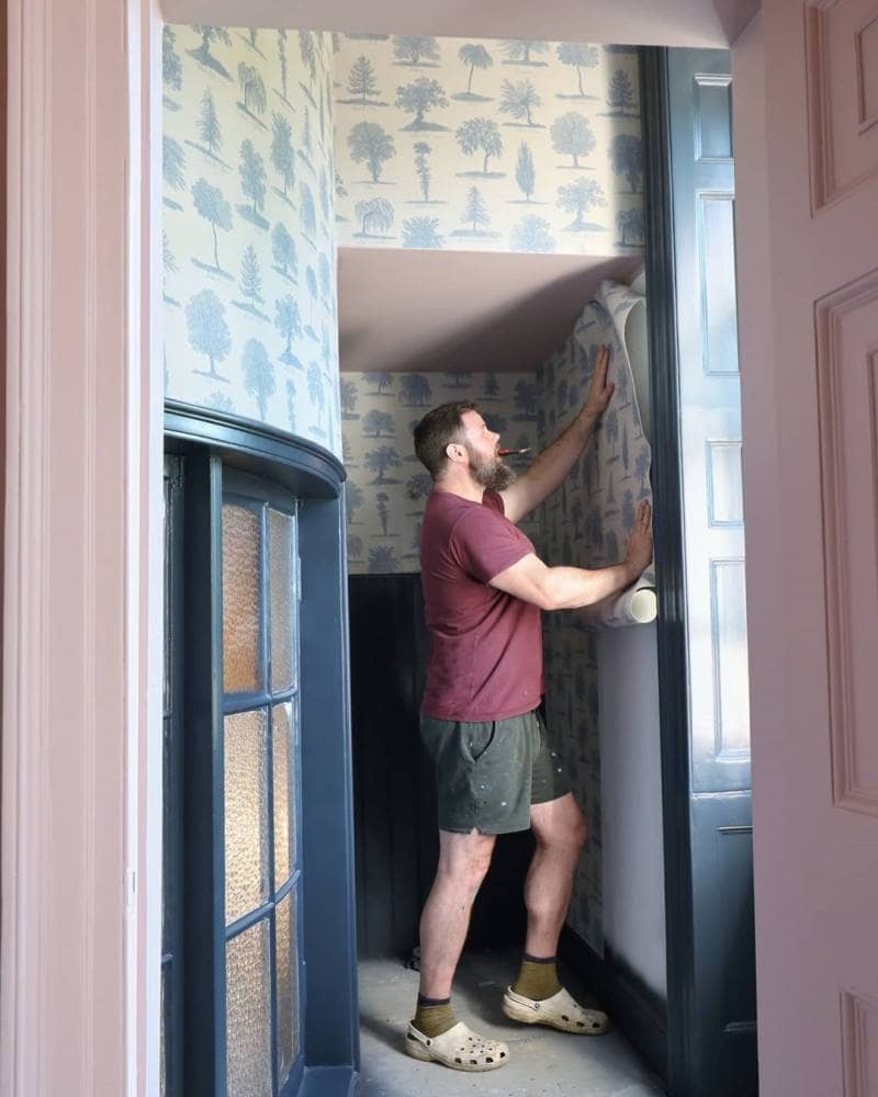 Greg putting up wallpaper