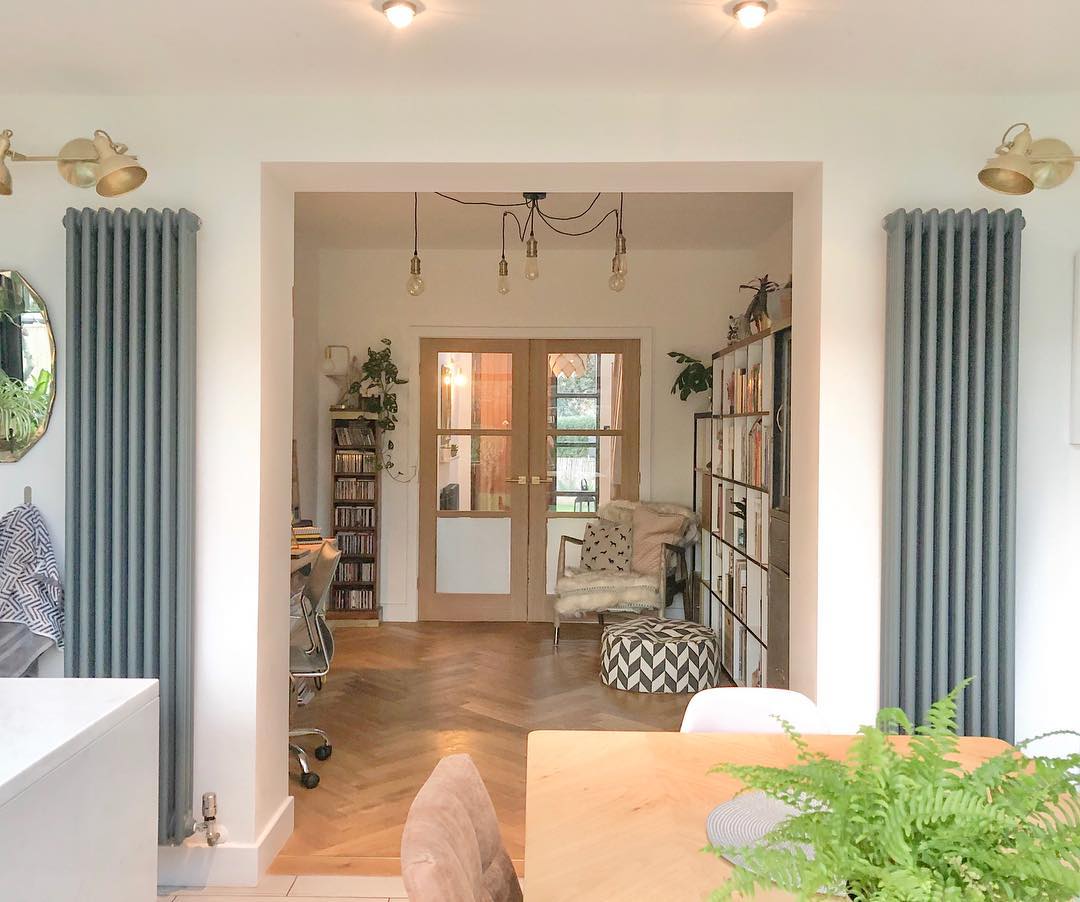 2 vertical radiators beside a doorway