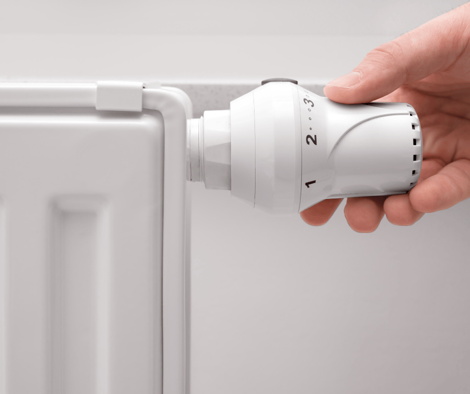 Hand turning a radiator valve