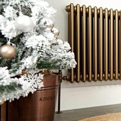 bronze column radiator next to a christmas tree