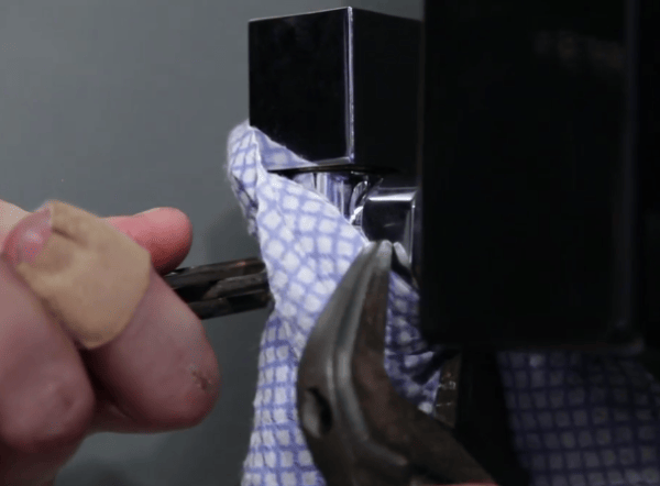 Valve being tightened with a spanner and a cloth