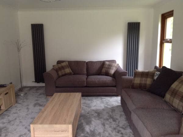 Double Vertical Designer Radiators placed on a wall in a sitting room making loads of space