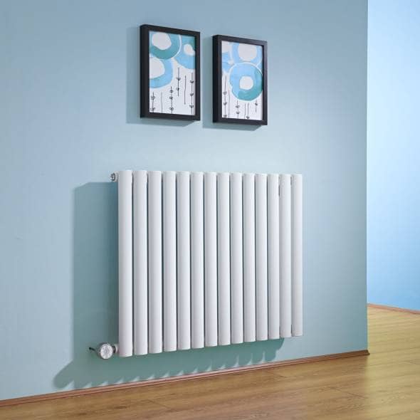 White electric designer radiator hung on a blue wall with two pictures above the radiator