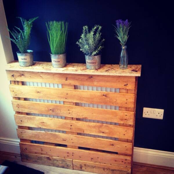 A Herb garden on top of a pallet style homemade radiator cover