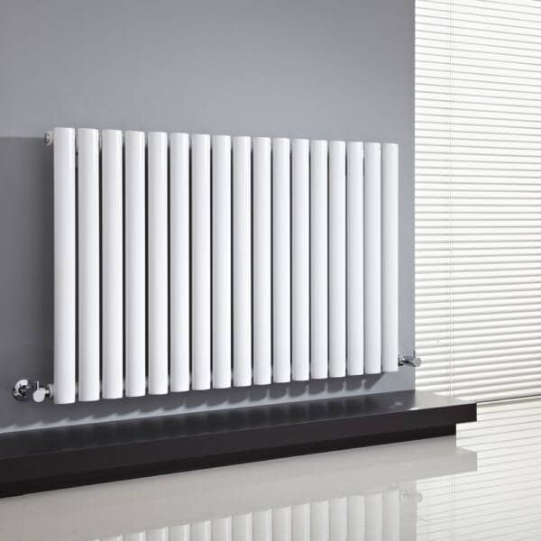 White designer radiator on a grey wall with a blind