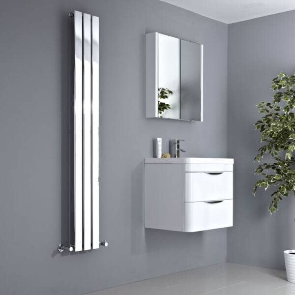 mirrored vertical radiator in a bathroom next to a sink
