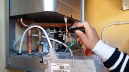 Gas central heating boiler being serviced