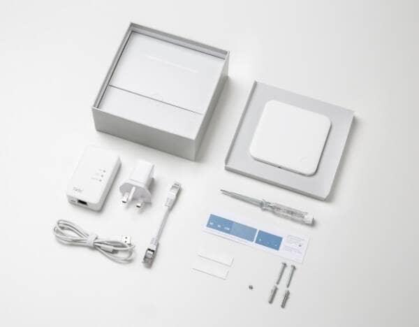 The tado smart thermostat box contents spread out on a table so each of the components are visible