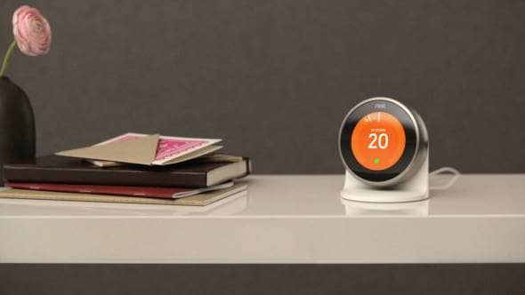 The nest learning thermostat on a desktop being used