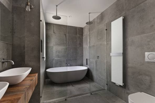 Lazzarini Ischia heated towel rail on a wall in a modern bathroom suite