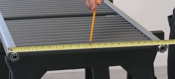 a tape measure being used to measure a heated towel rail