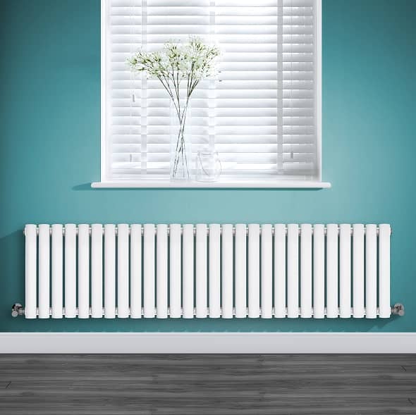 A low level radiator on a green wall