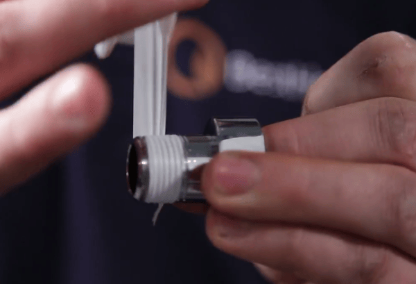 man wrapping ptfe tape around a radiator valve
