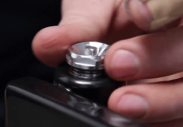 Man winding in a bleed valve to a radiator