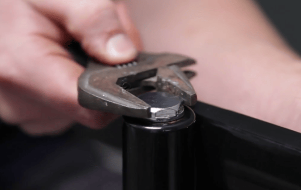 A spanner tightening a blanking plug on a radiator