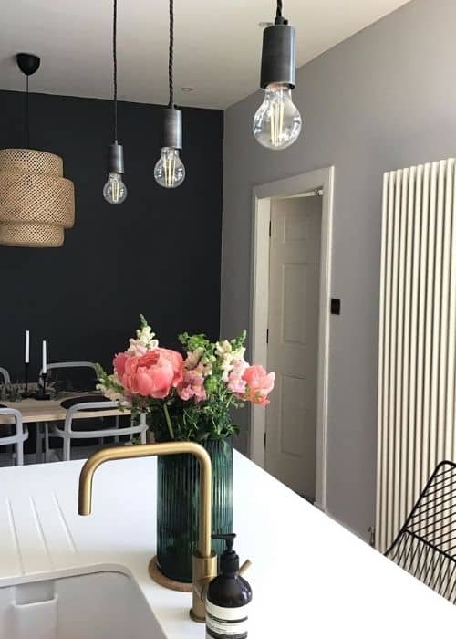 flowers on a kitchen island next to a vertical radiator