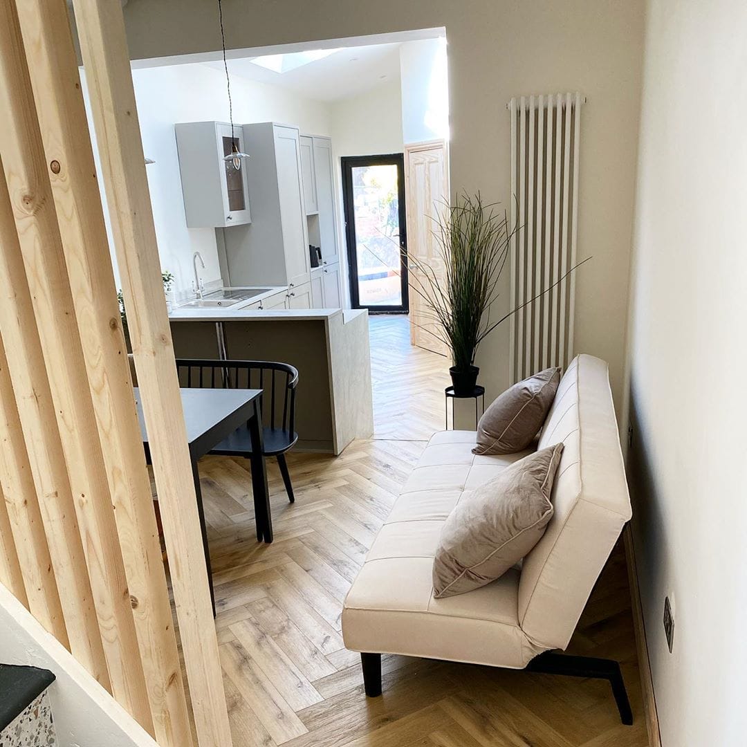 white vertical radiator in a neutral living room