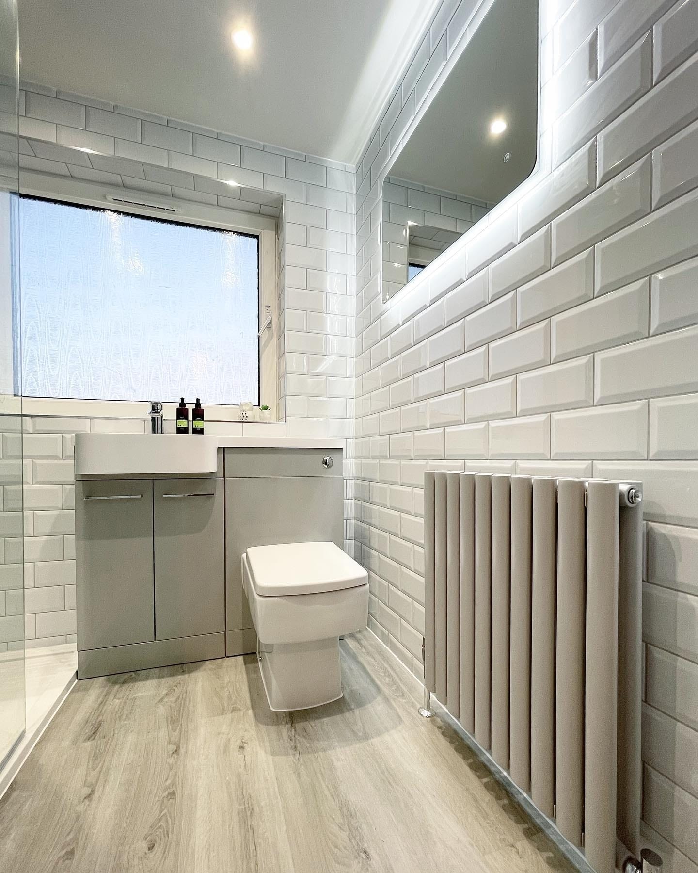 small grey radiator in a modern bathroom
