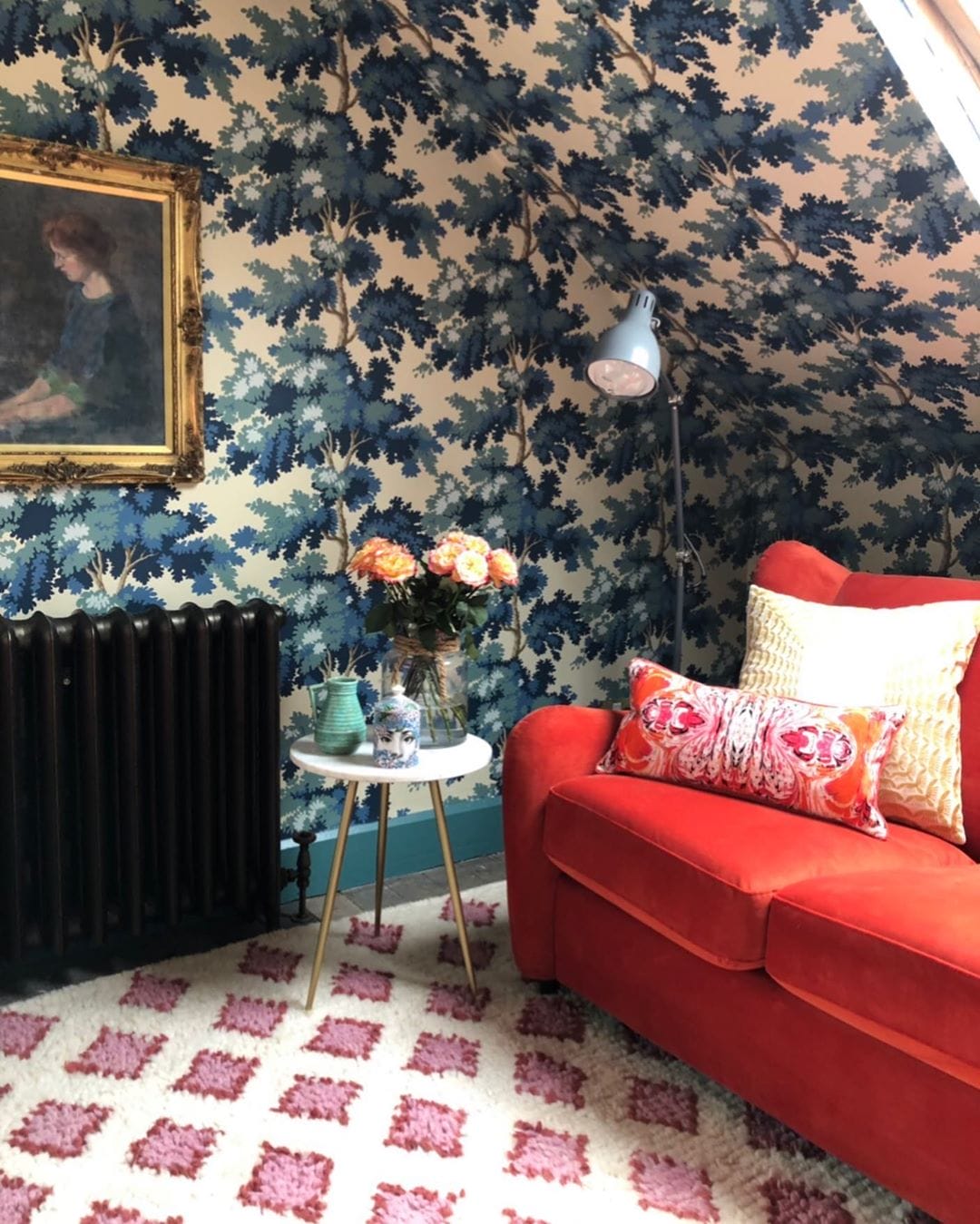 cast iron radiator on blue floral wallpaper