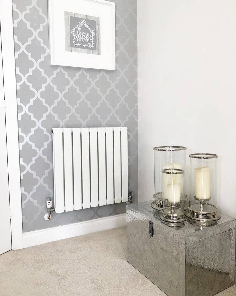 A white Milano Alpha designer radiator with thermostatic valves.