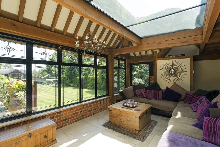 Large conservatory with cushioned benches on a sunny day