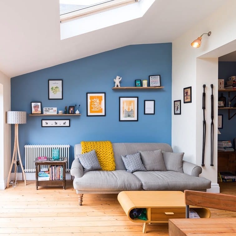 blue and white living room with a column radiator