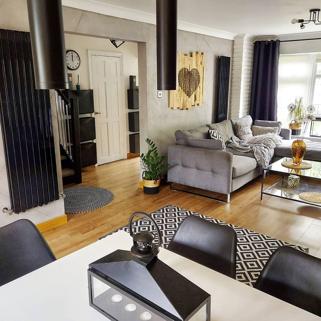 2 black radiators in a rustic living room