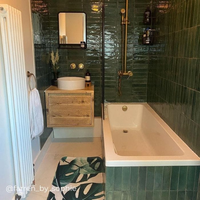 white vertical radiator in a green bathroom