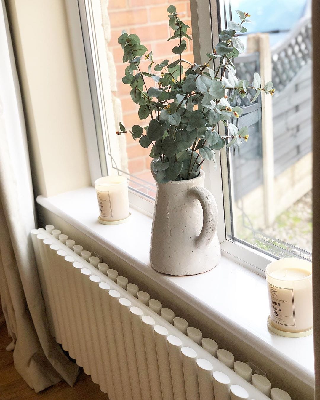 close up of a white designer radiator under a window