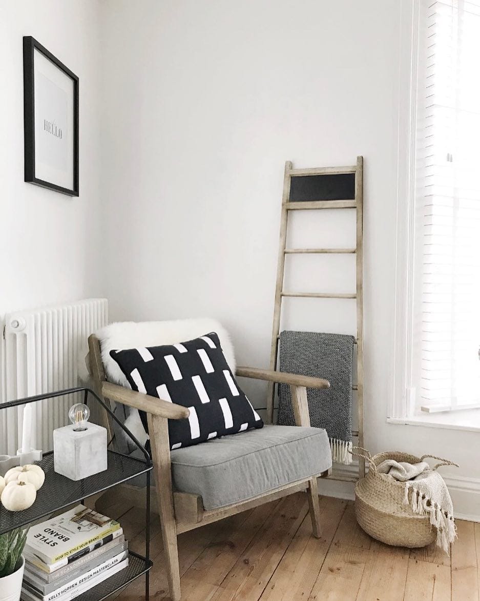 wooden chair and ladder next to a white radiator