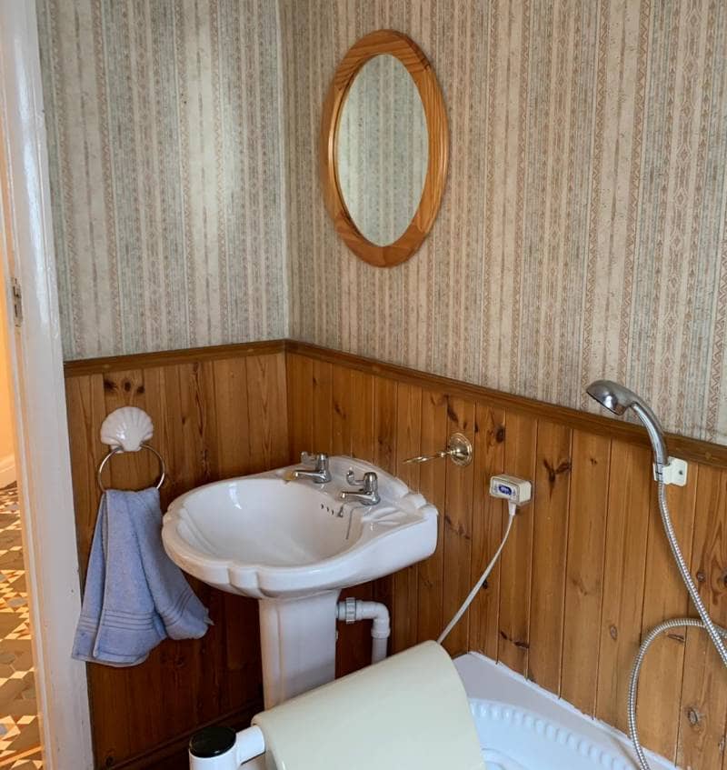an old basin in a wooden bathroom