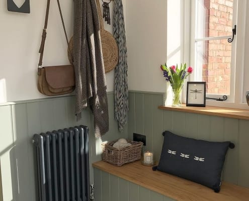 narrow anthracite column radiator in a small boot room