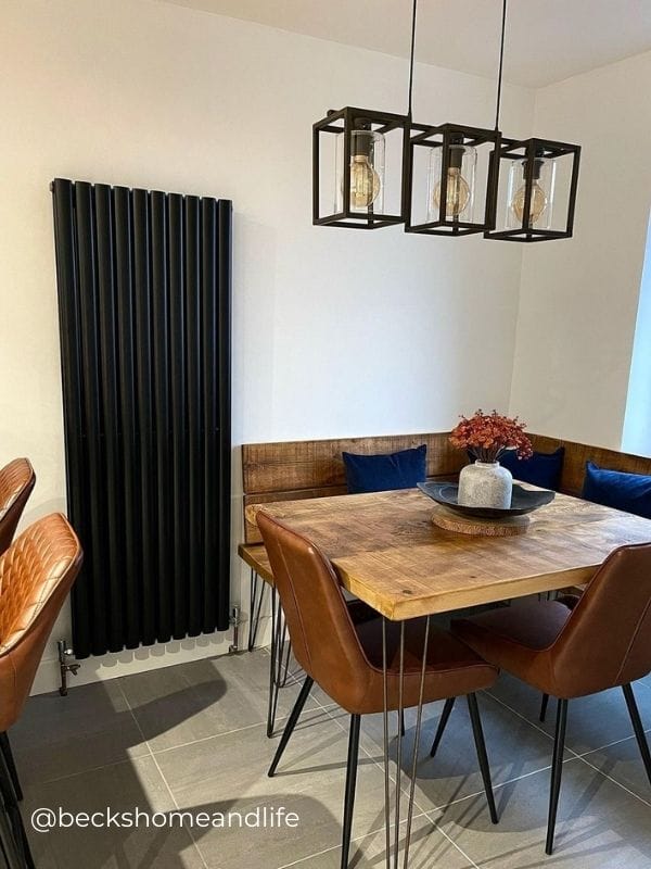 Modern vertical black radiator in modern dining room Modern vertical black radiator in a modern dining room area