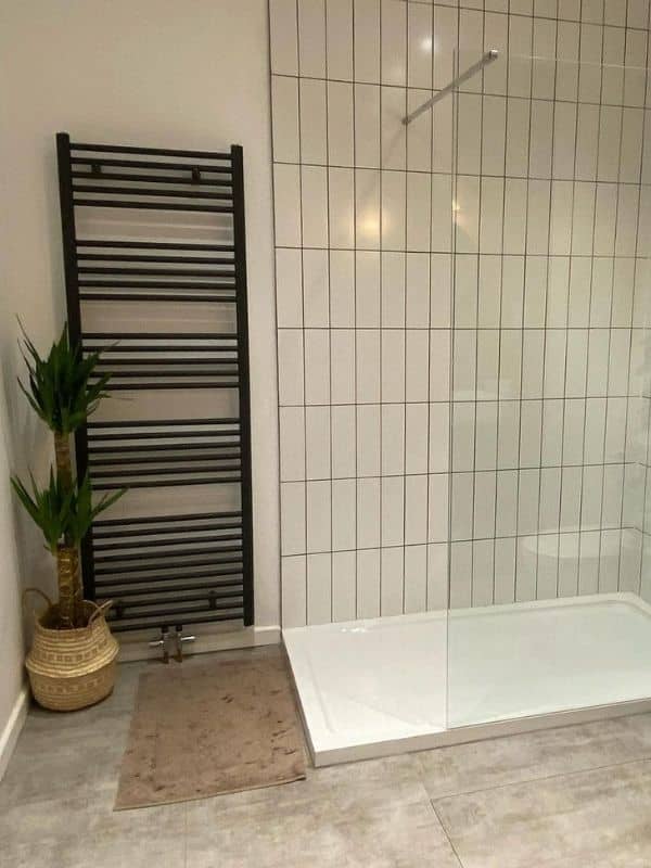 Milano Neva large ladder style heated towel rail in a modern bathroom