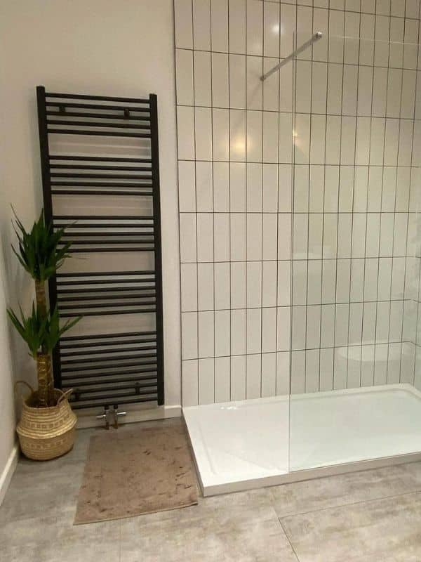 large ladder style heated towel rail in a modern bathroom