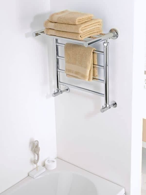 Milano Pendle shelf style heated towel rail in a bathroom with towels