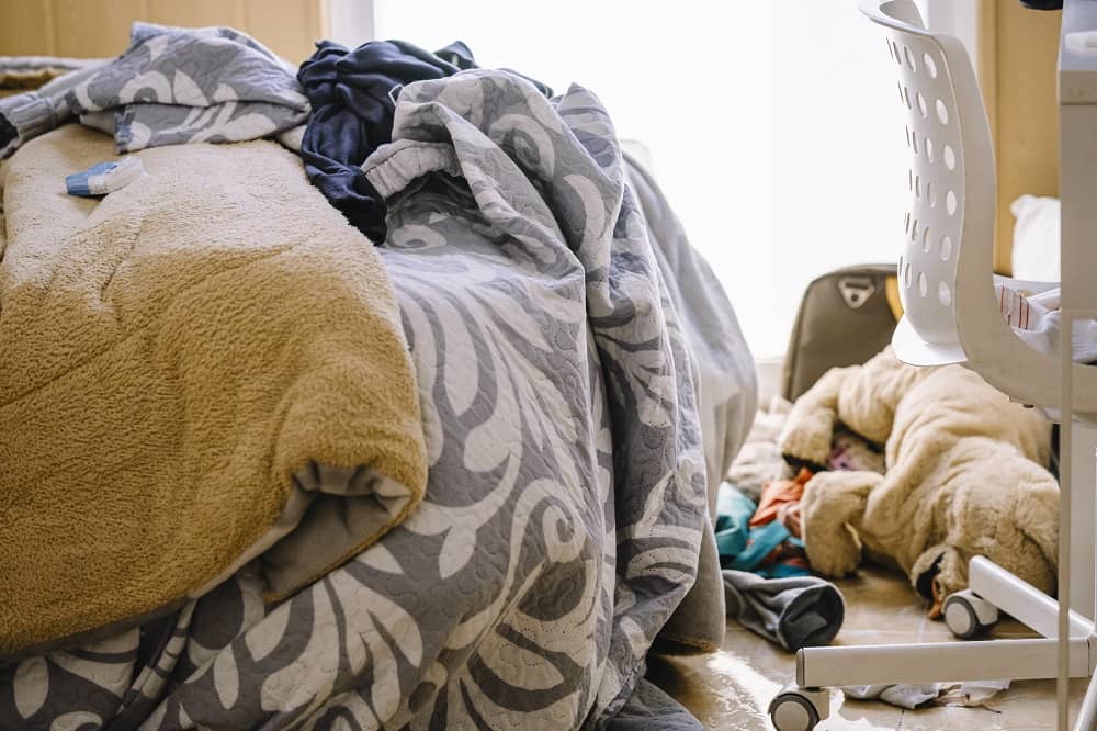 Messy teen room with clothes lying on the floor.