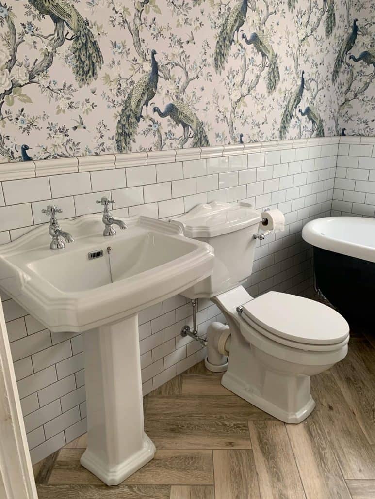 a basin and toilet in a traditional bathroom