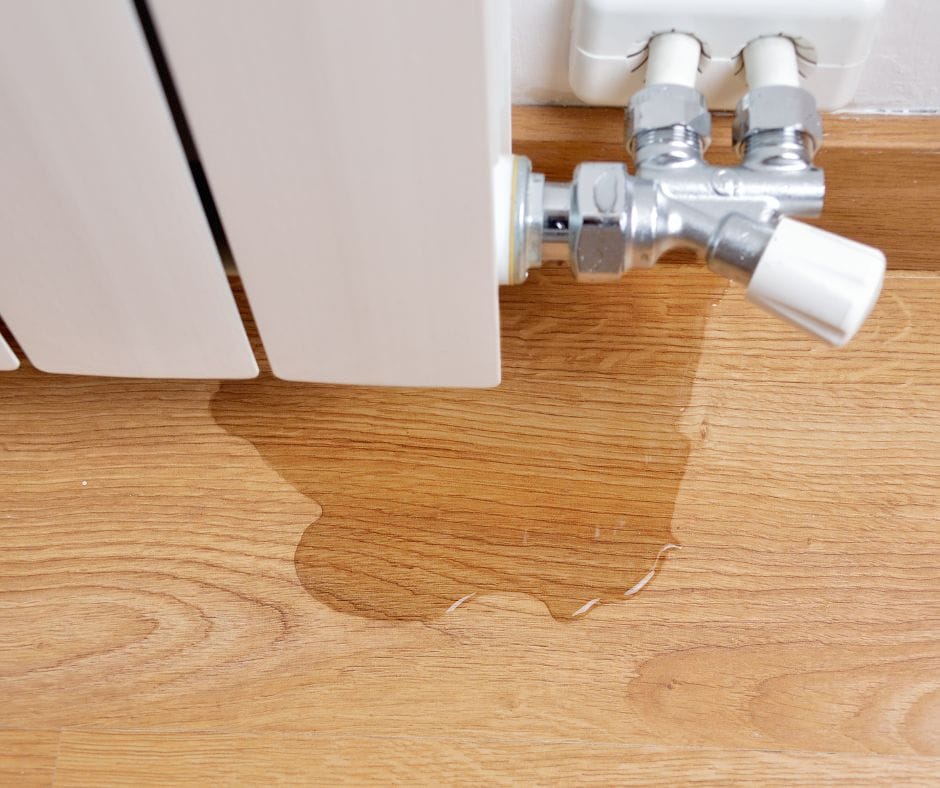 water leaking out of a radiator onto the floor
