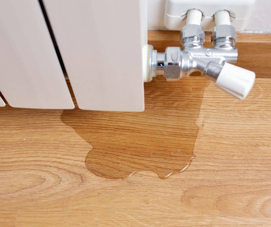 water leaking out of a radiator onto the floor