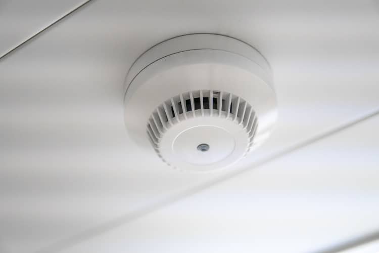 A carbon monoxide alarm on a ceiling