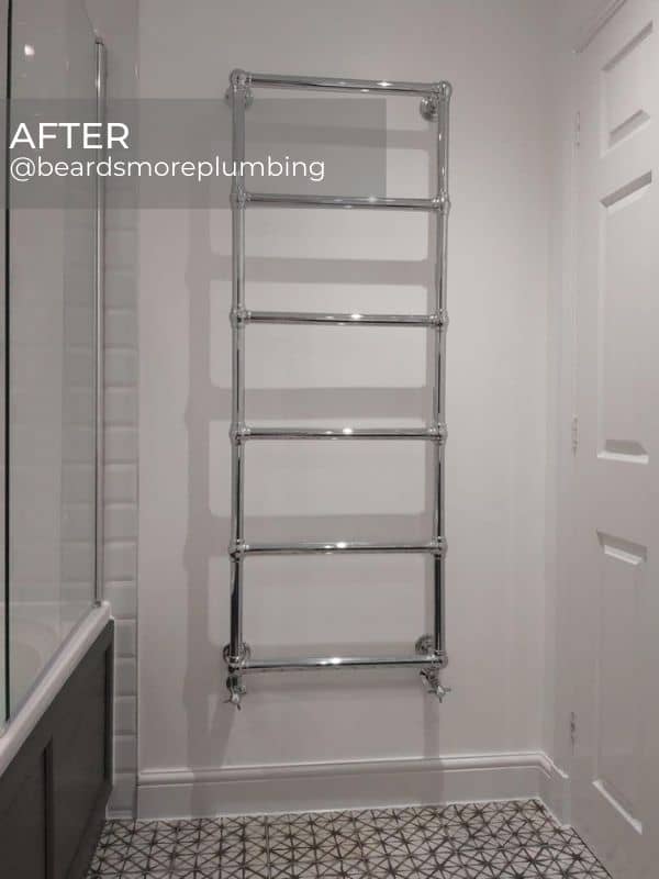 traditional heated towel rail in a white bathroom