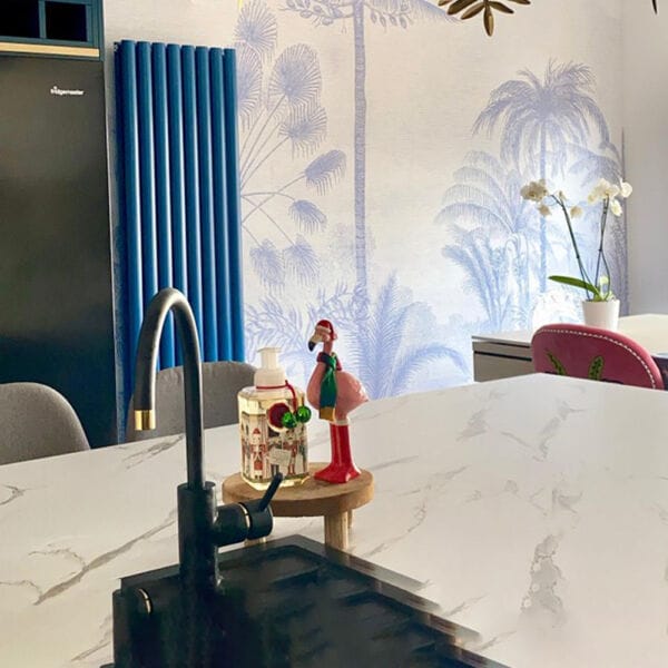 Blue designer radiator in a kitchen diner in place of a heated towel rail 