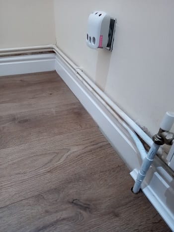 radiator pipes running along a skirting board