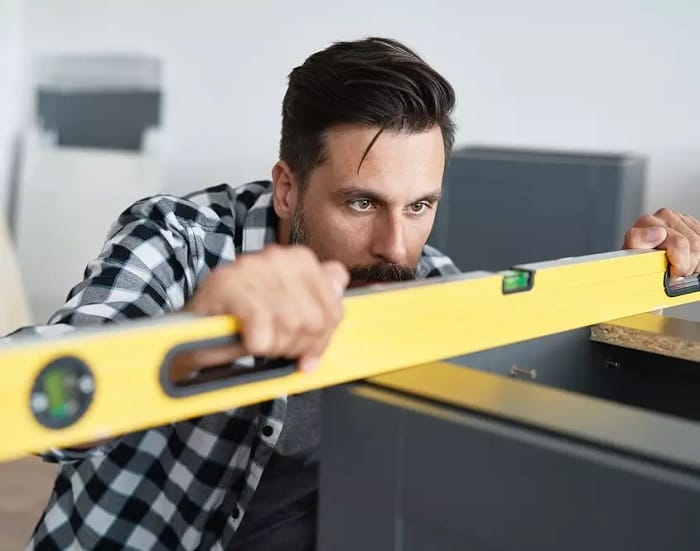 Man using large yellow spirit level