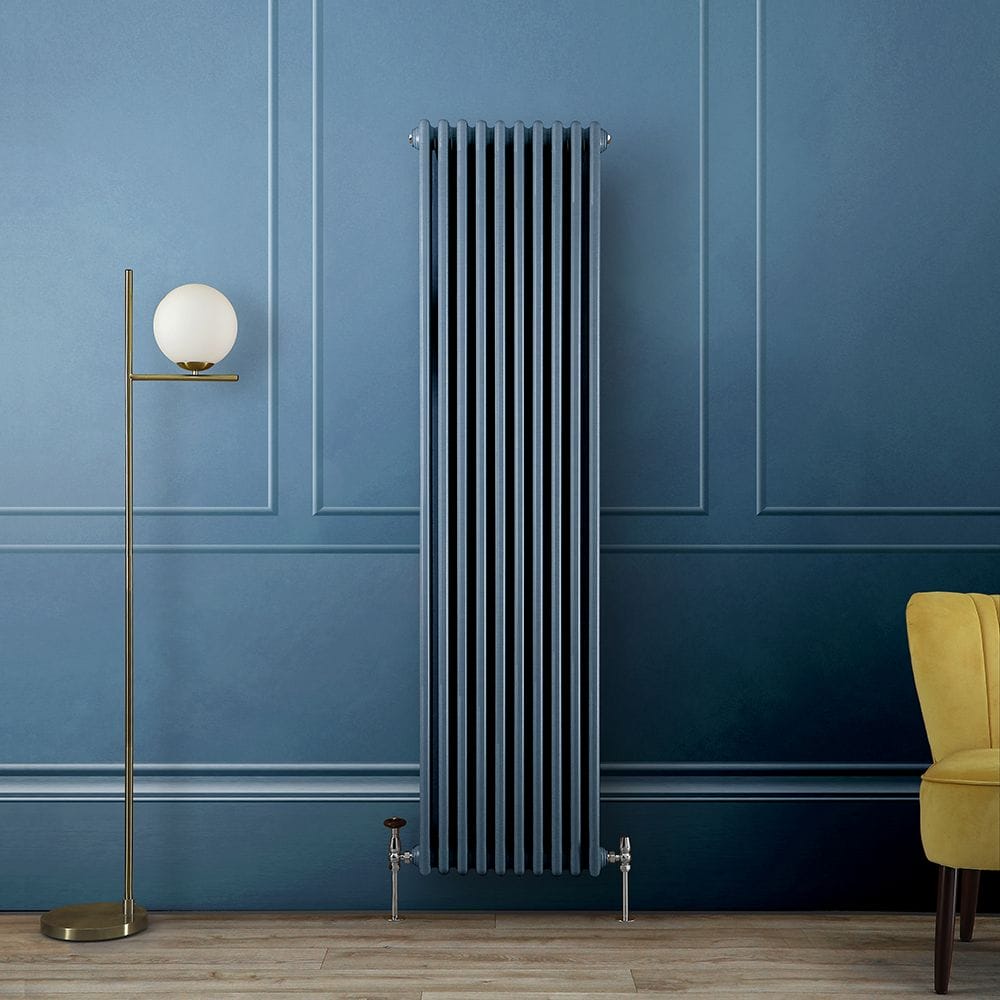 A tall blue column radiator against a matching blue wall